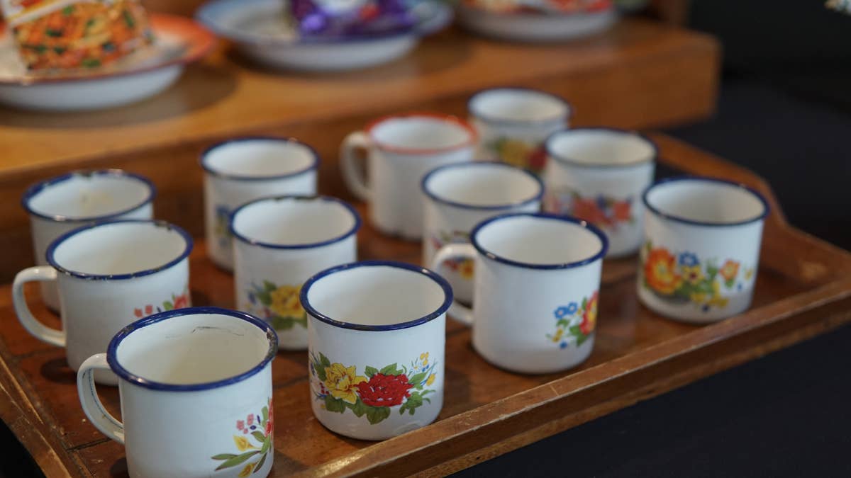 vintage-floral-enamel-mugs-on-rustic-wooden-tray-traditional-tableware
