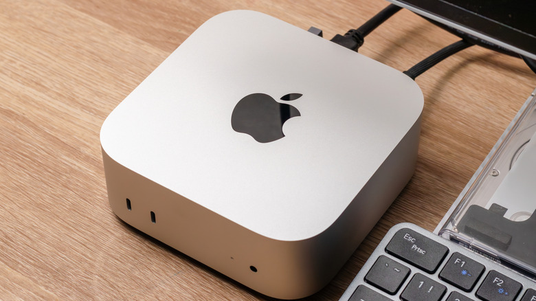 SIlver M4 Mac Mini on a wooden desk