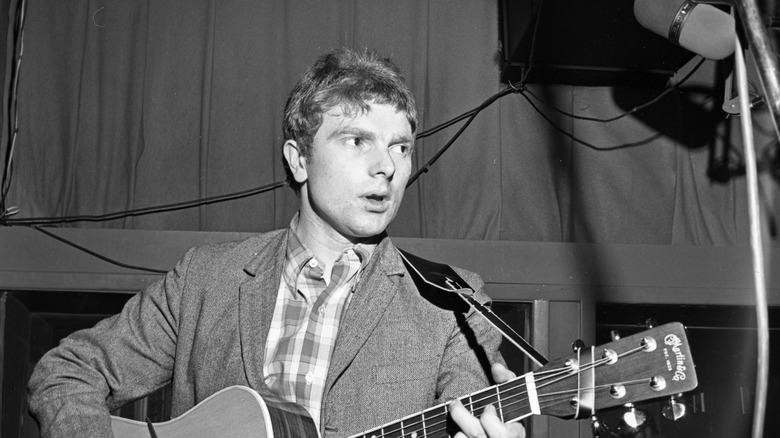 Van Morrison singing and playing guitar and looking away
