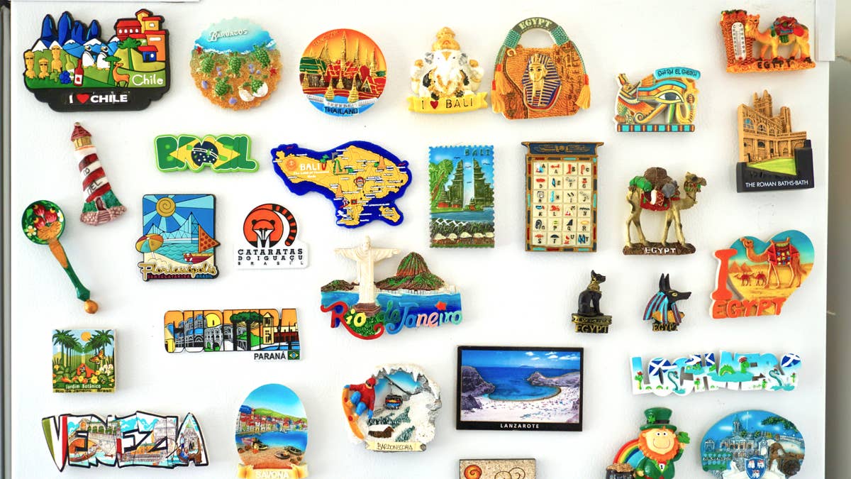 a-collection-of-fridge-magnets-from-around-the-world-arranged-on-a-fridge-door
