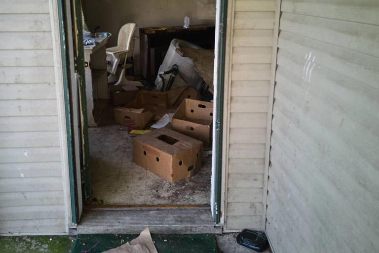 Items including a high chair are seen in a home where authorities say they removed 16 children and arrested four adults