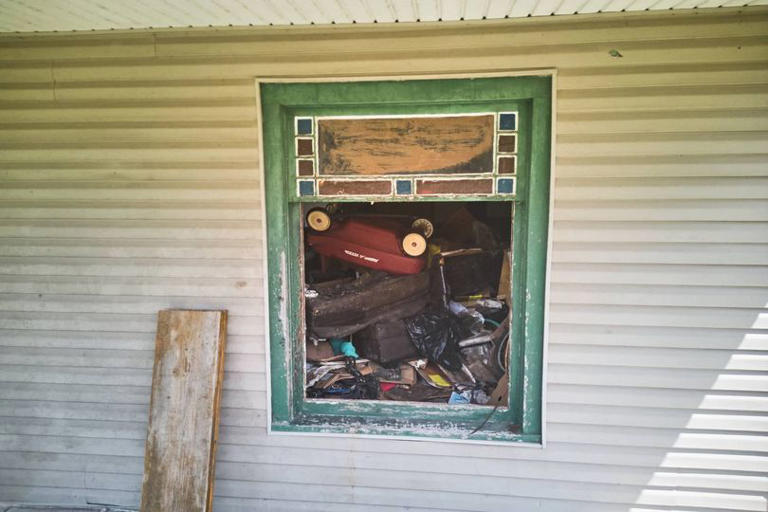 Debris is seen inside a home where authorities say they removed 16 children and arrested four adults