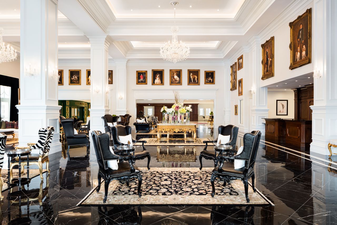 A luxurious hotel lobby with chandeliers and ornate furniture