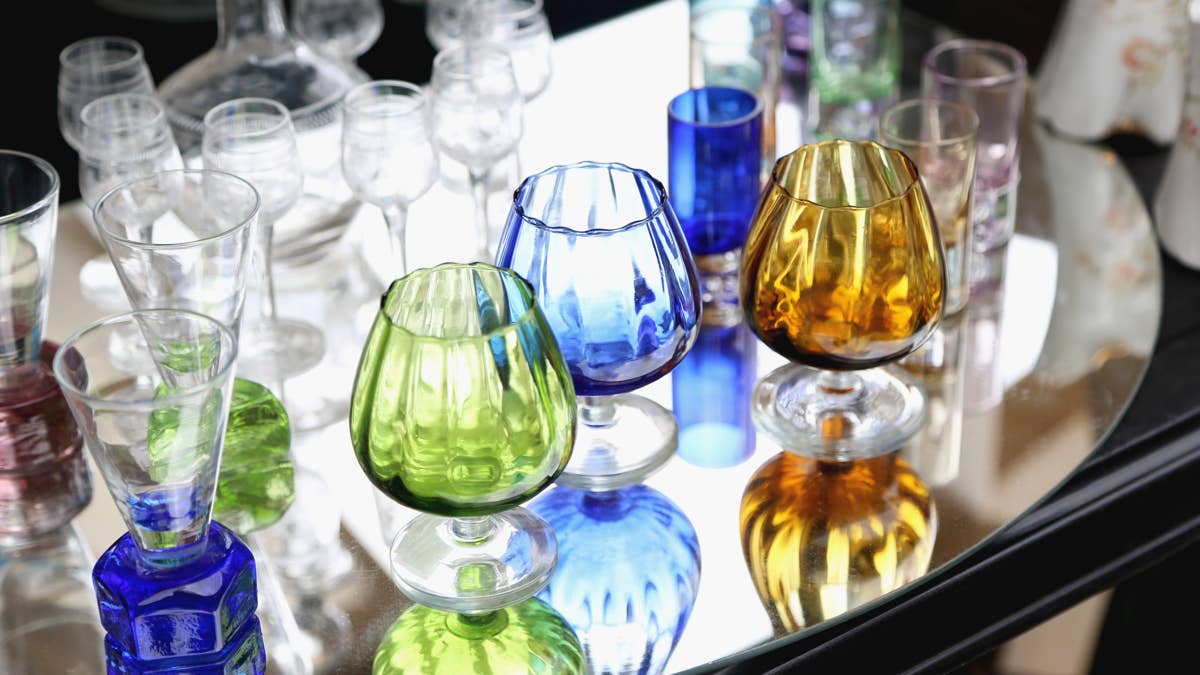 vintage-crystal-wineglasses-and-retro-shot-glasses-against-mirror-background-at-the-local-flea-market