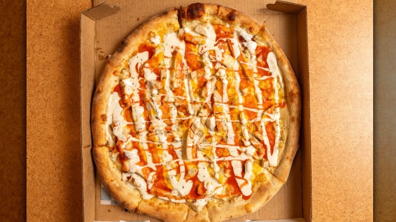 Overhead view of a Domino's Buffalo Chicken Pizza in a pizza box