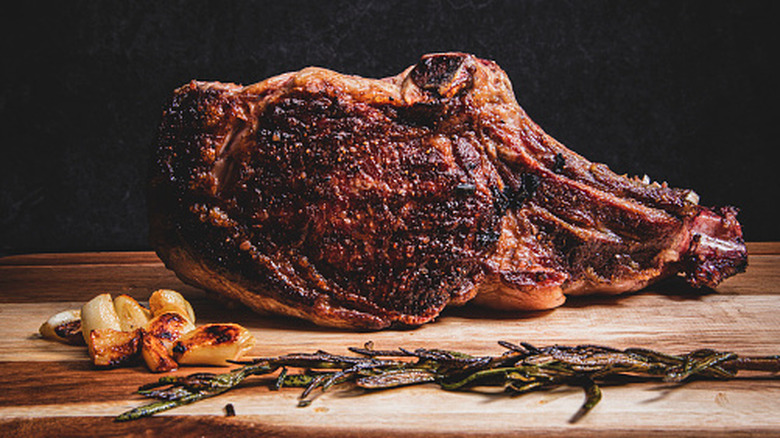 Standing bone-in rib roast with garlic and rosemary.