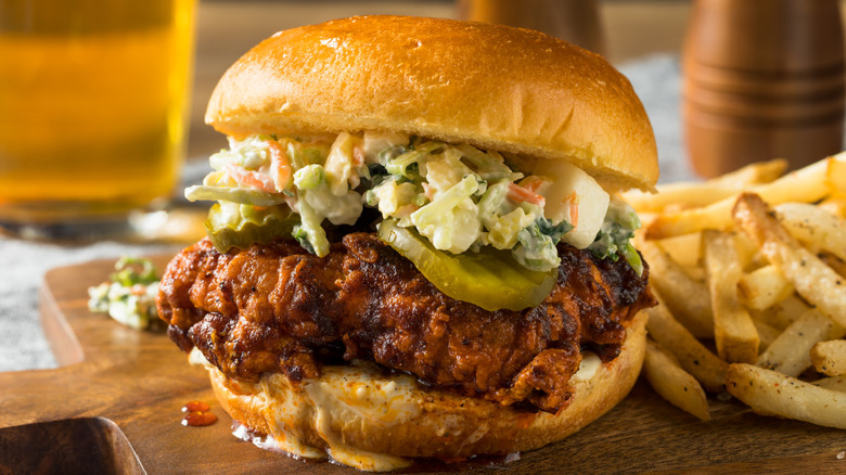 Closeup of a Nashville hot chicken sandwich and fries