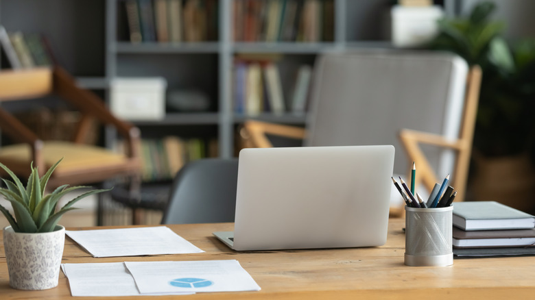 A home office setup with a laptop on a desk