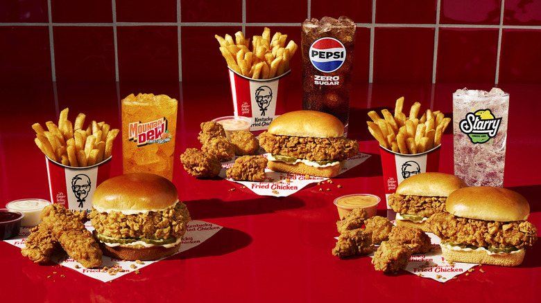 A variety of KFC chicken sandwiches, fries, and drinks