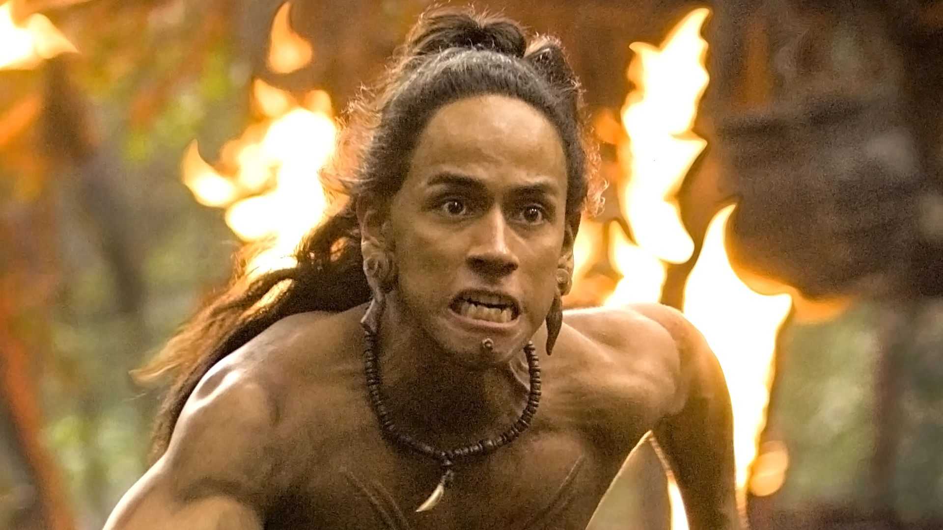 Jaguar Paw (Rudy Youngblood) running through a flaming village in Apocalypto.