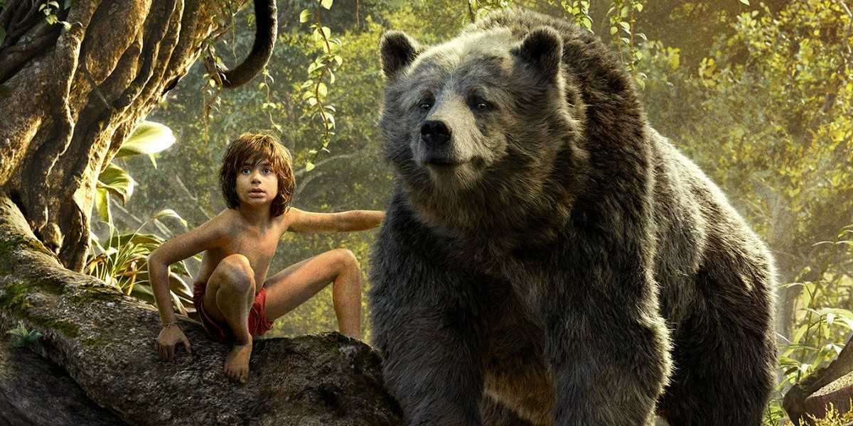 Mowgli and Baloo sitting on a branch in The Jungle Book