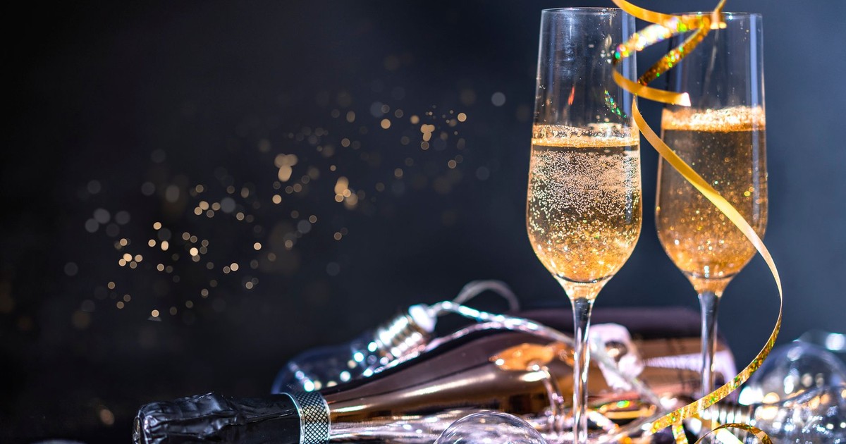 Two champagne glasses with a bottle and festive decorations, perfect for celebrations.