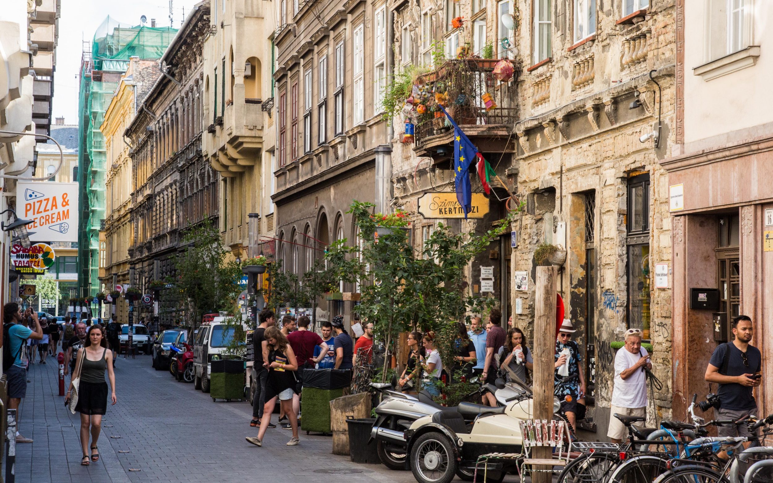 Budapest, Hungary. People gathered outside the Szimpla Kert in Kazinczy Street, the best-known of many 'ruin pubs' in the Jewish quarter
