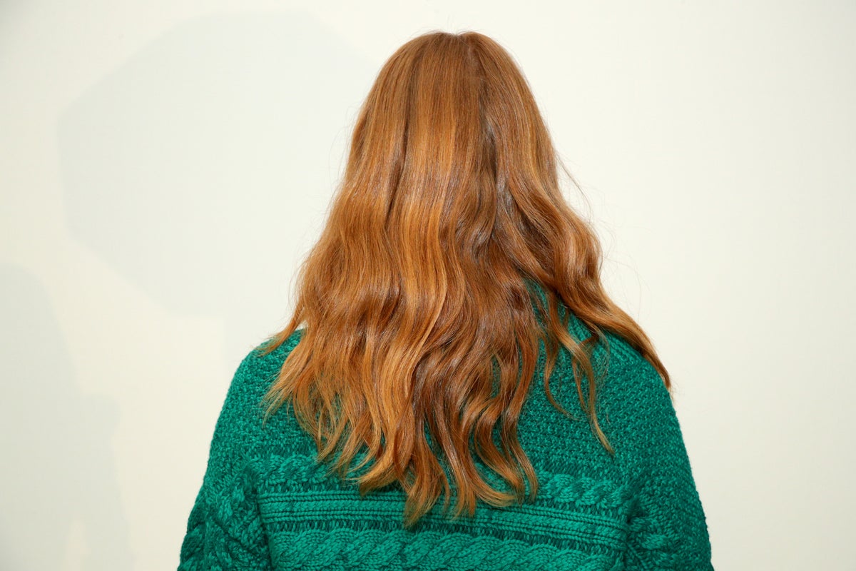 A model poses for a photo backstage at TRESemme x Alice + Olivia