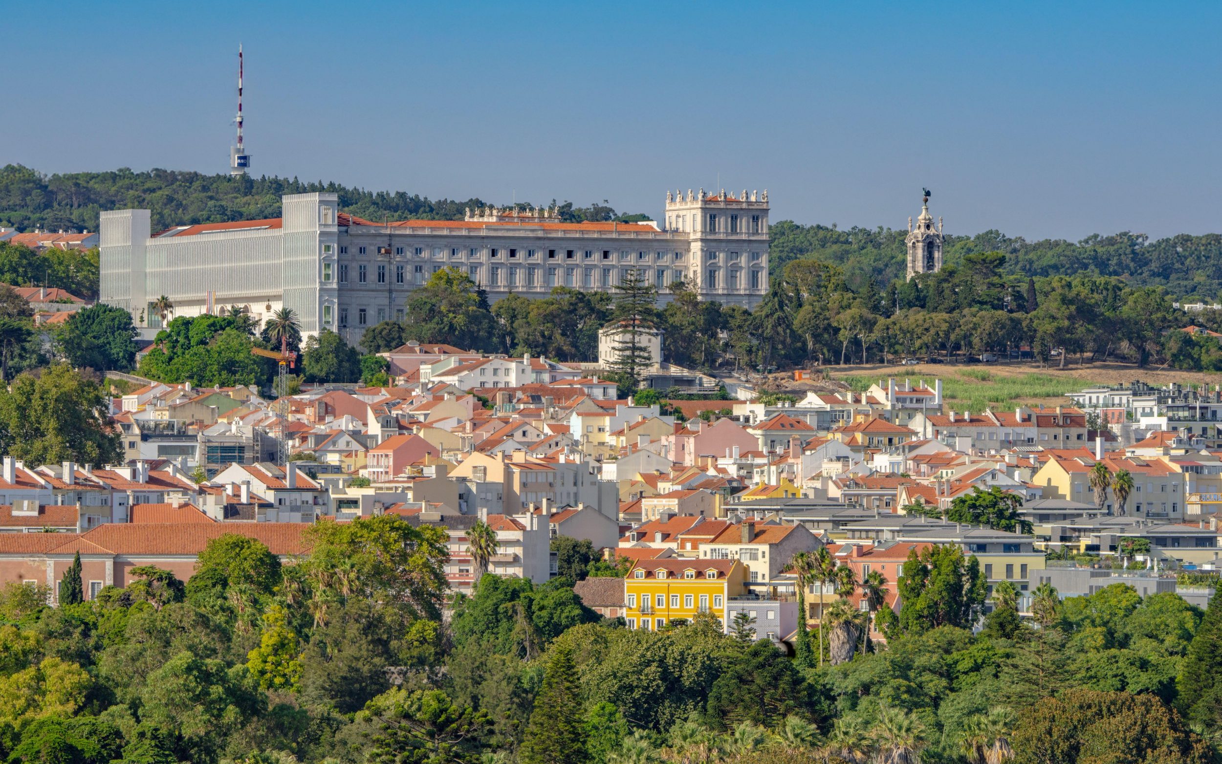 Ajuda Palace overlooking residential neighborhoods and green hills, Lisbon, Portugal