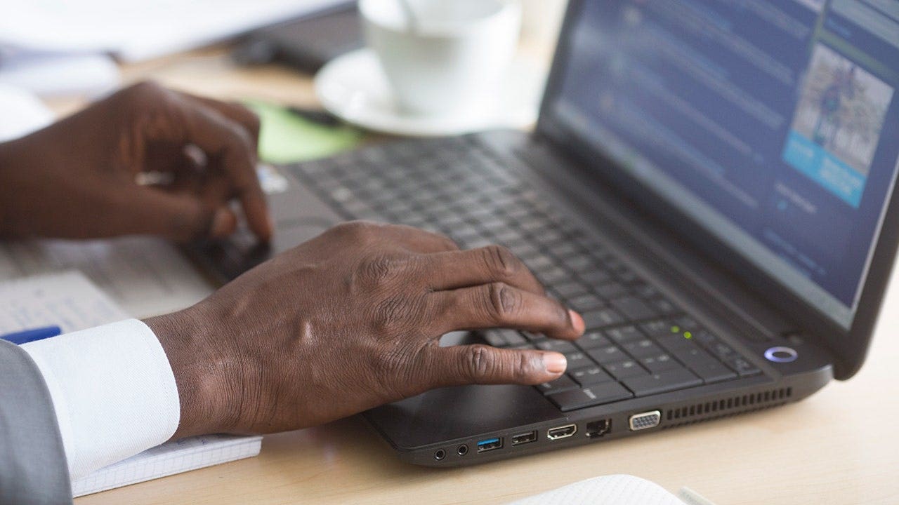 Man typing on his computer.