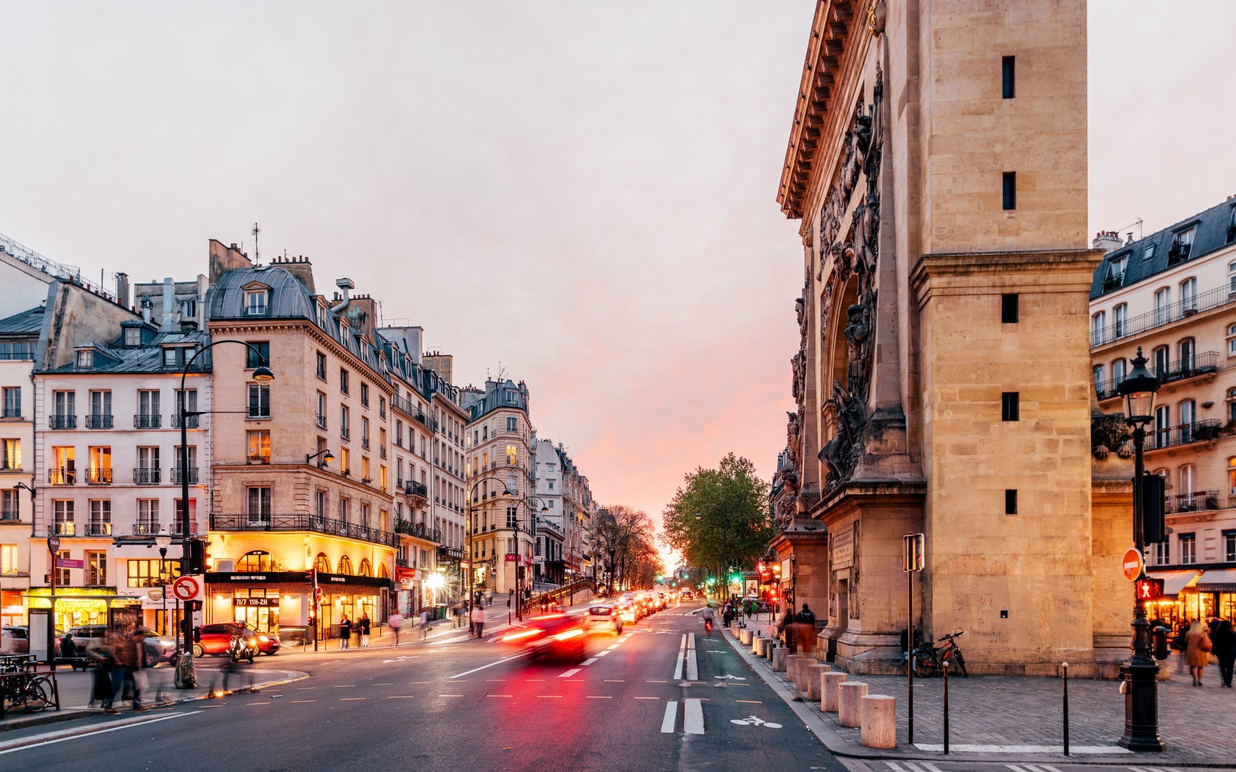Porte Saint-Denis arch and Saint Martin boulevard at sunset, Paris, France