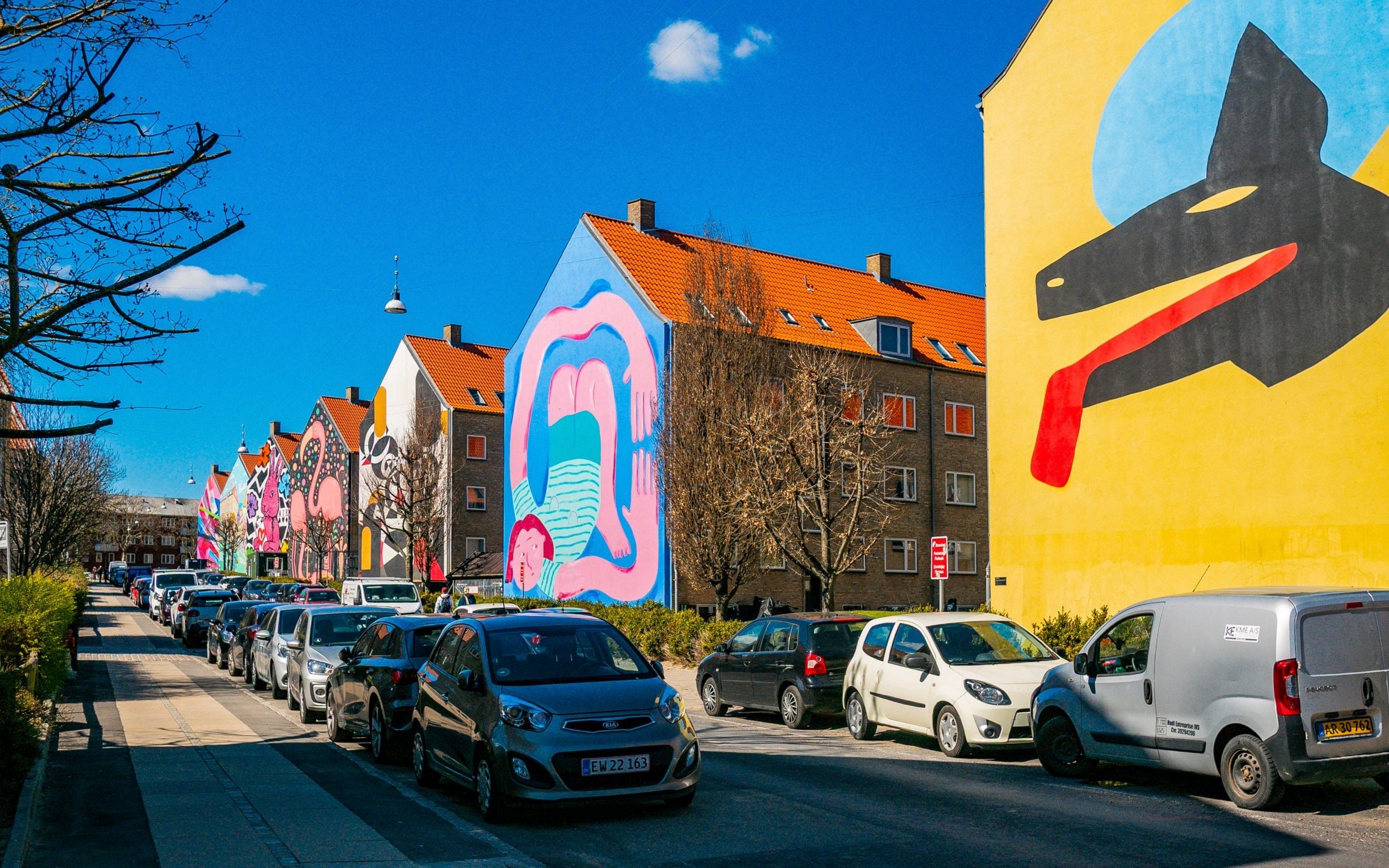 Colorful gable murals line a street in the Nordvest district, Copenhagen, Denmark