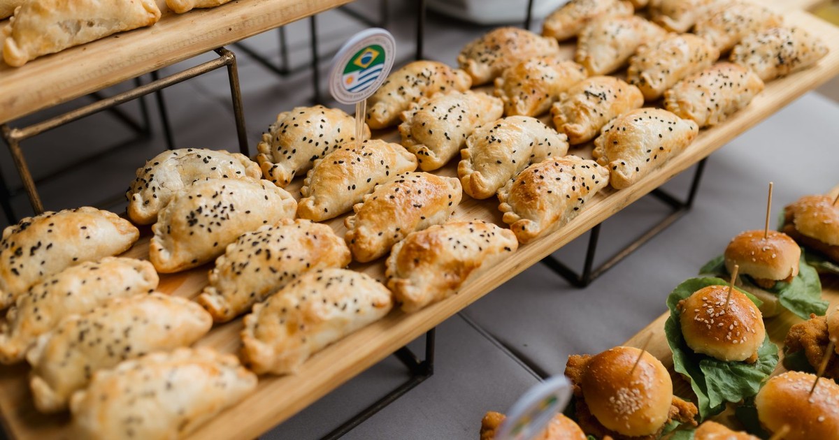 Assorted savory pastries and sliders elegantly displayed, perfect for catering or events.