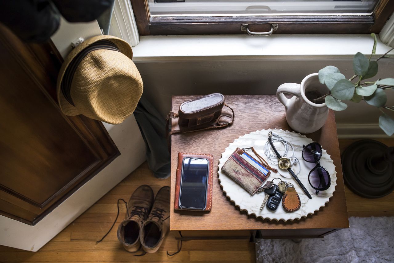 cluttered entryway table in foyer