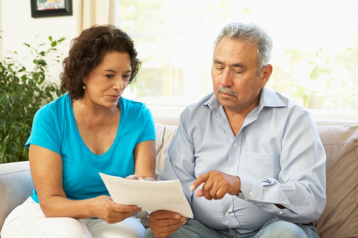 Two people discussing a document together.