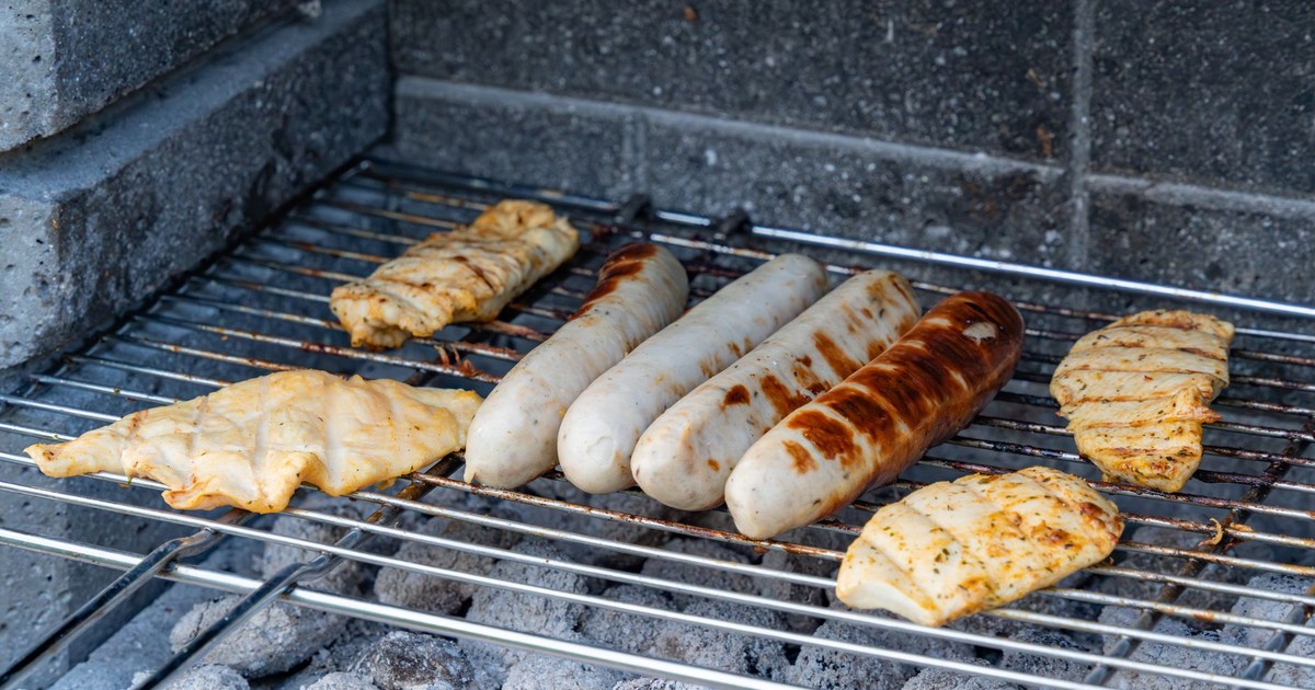 Delicious grilled sausages and chicken on a barbecue grill. Perfect for summer cookouts.