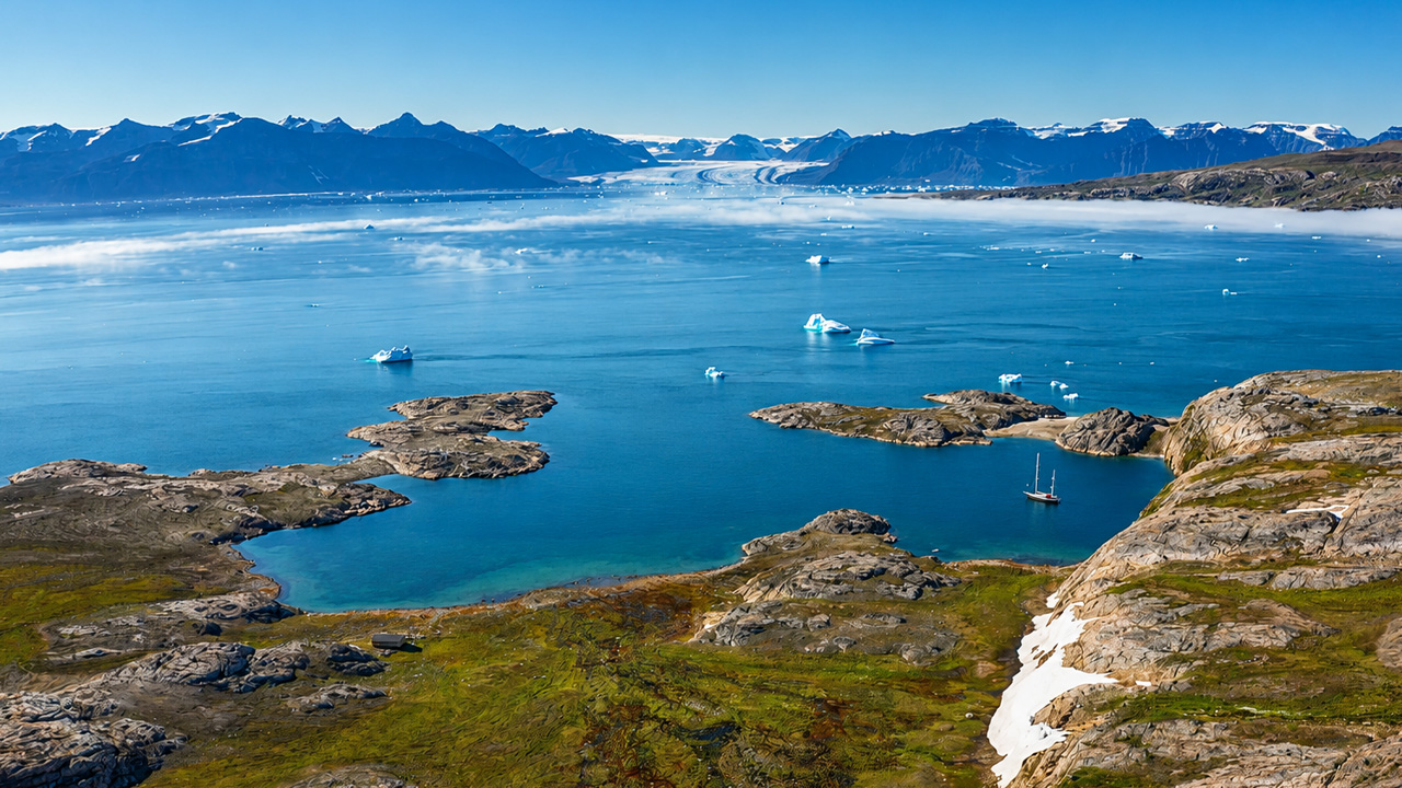 Greenland coast with icebergs and blue Arctic water