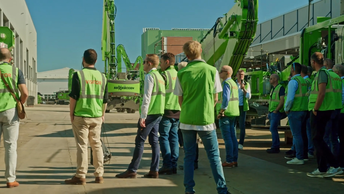 Visitors explore the manufacturing process behind modern heavy machinery