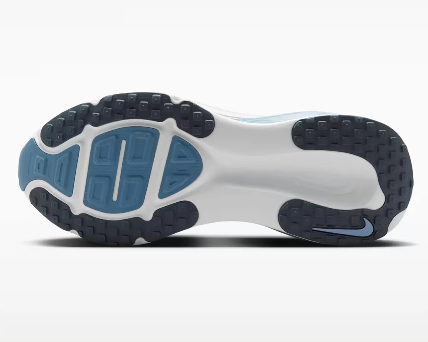 White and blue Nike shoe sole with black and blue tread and a blue Nike swoosh logo near the heel.