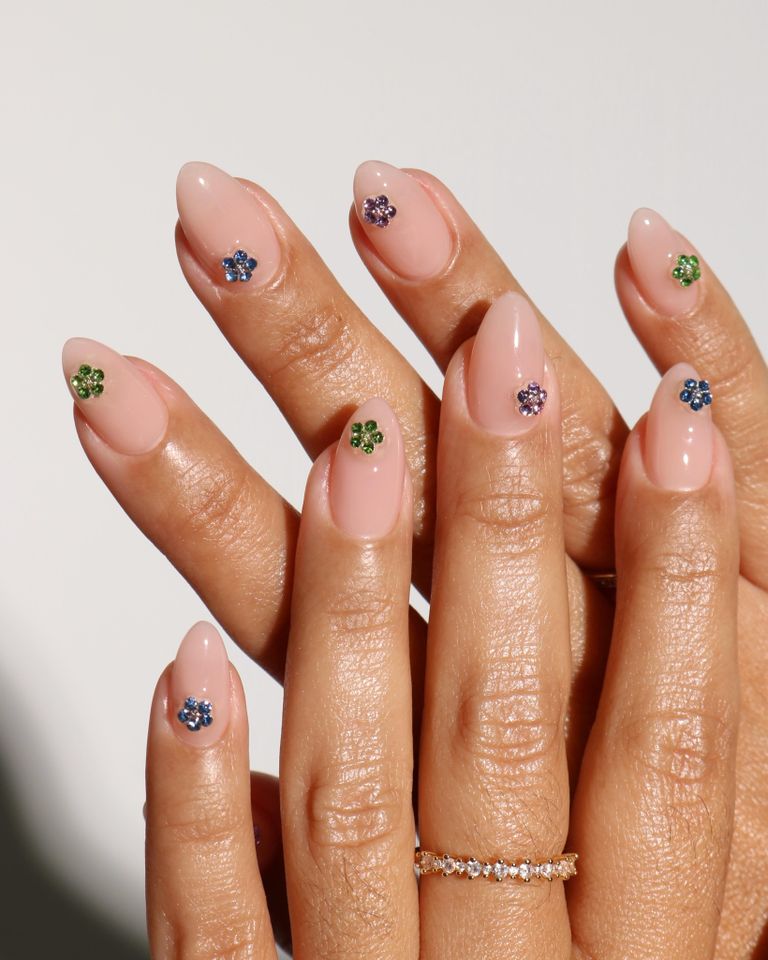 Nude nails with multicolored gemstone flowers