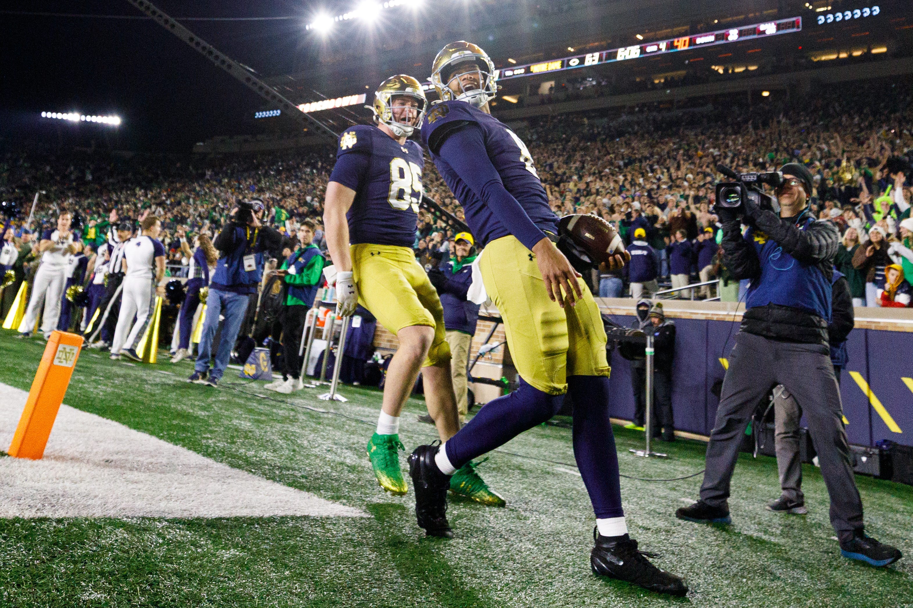 Notre Dame quarterback Kenny Minchey, right, celebrates after scoring a touchdown in the second half of a NCAA football game against Syracuse at Notre Dame Stadium on Saturday, Nov. 22, 2025, in South Bend.