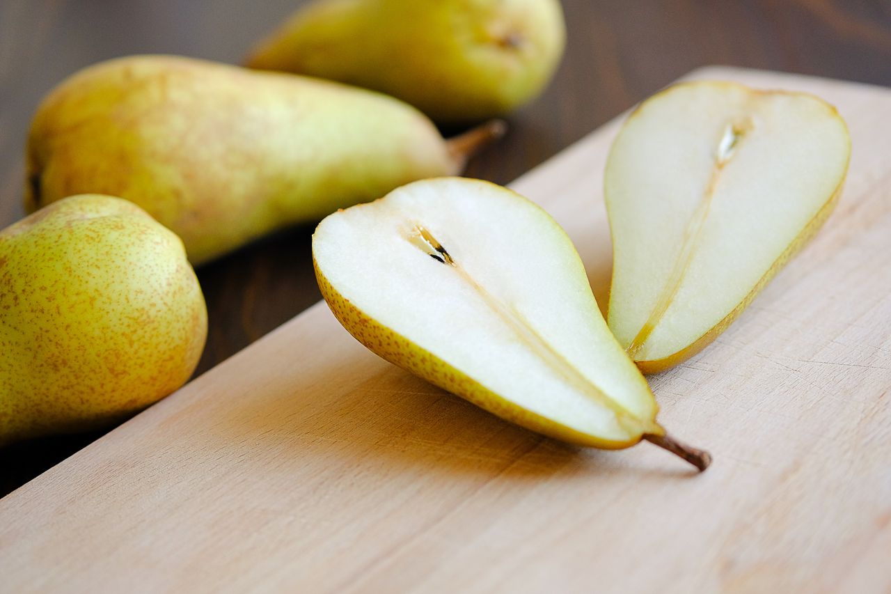 Sliced halves or slices of pear on cutting board