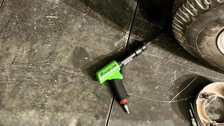 Snap-On air hammer next to car