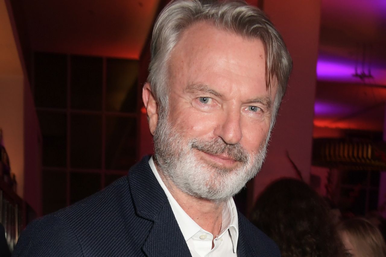 Sam Neill smiling indoors