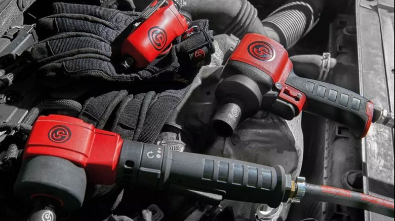 Chicago Pneumatic tools sitting on car's engine compartment