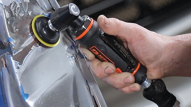using Dynabrade right andle die grinder on car body