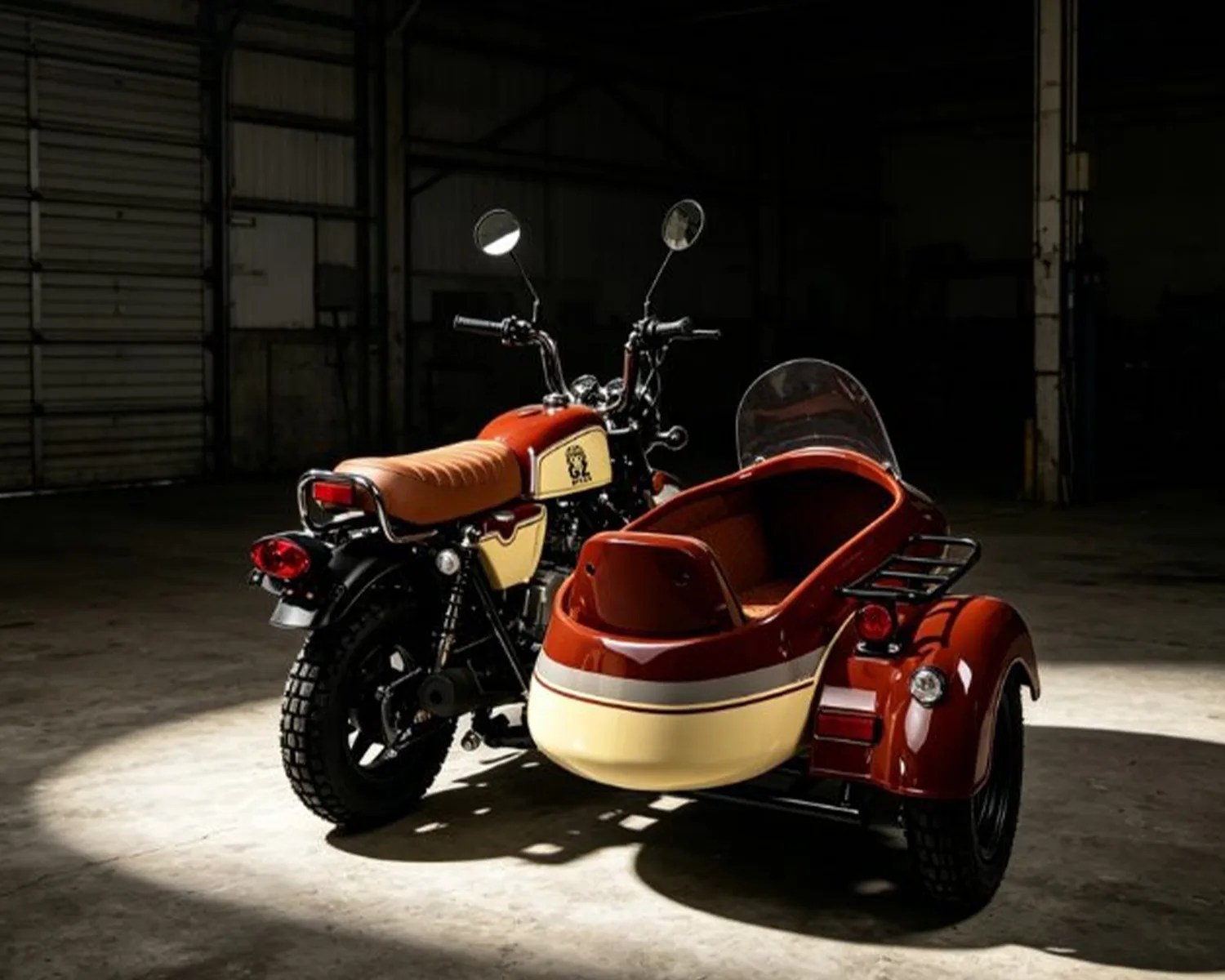 Red and cream motorcycle with a matching sidecar in a dimly lit garage.