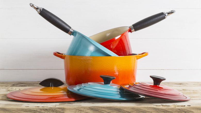 Array of various Le Creuset cookware with different types of knobs