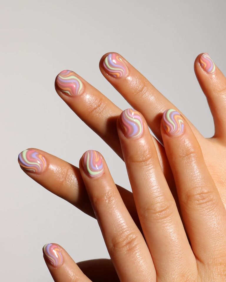 Clear nails with swirling pastel lines