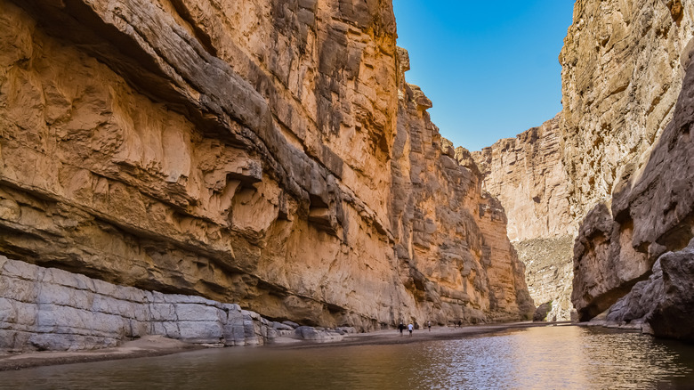 Hikers walking in Santa Elena Canyon in Big Bend National Park, Texas.