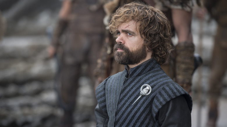 Tyrion standing wearing his Hand of the Queen pin on Game of Thrones