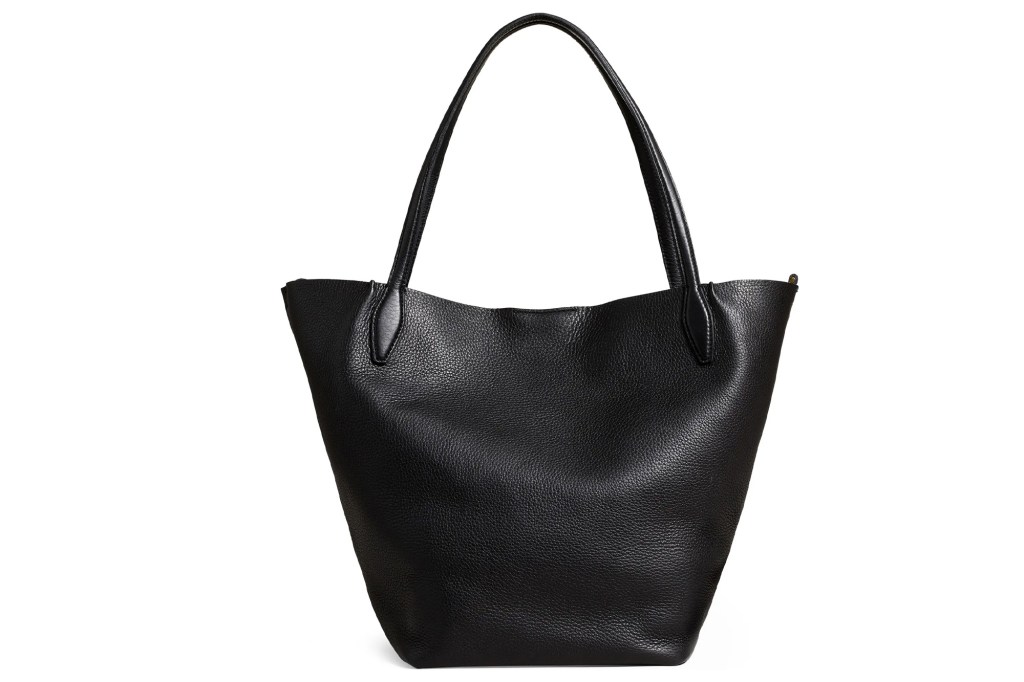 Black leather tote bag with subtle grain and a single curved handle.