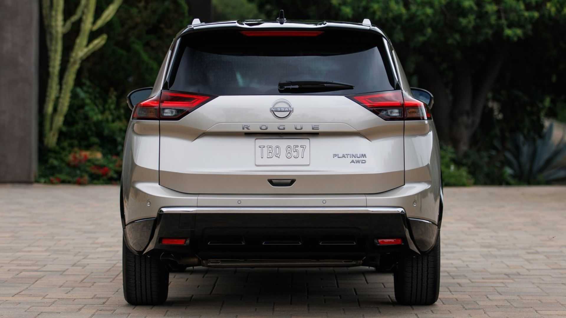 Static rear-end shot of a gold 2024 Nissan Rogue.