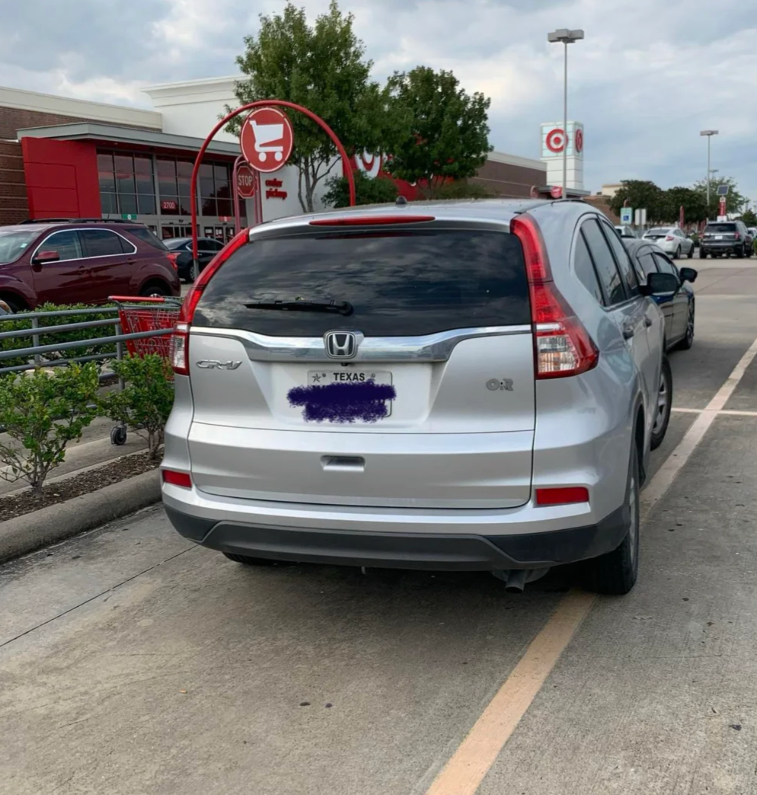 A white SUV parked diagonally across two parking spaces in a parking lot. Text above criticizes the parking behavior