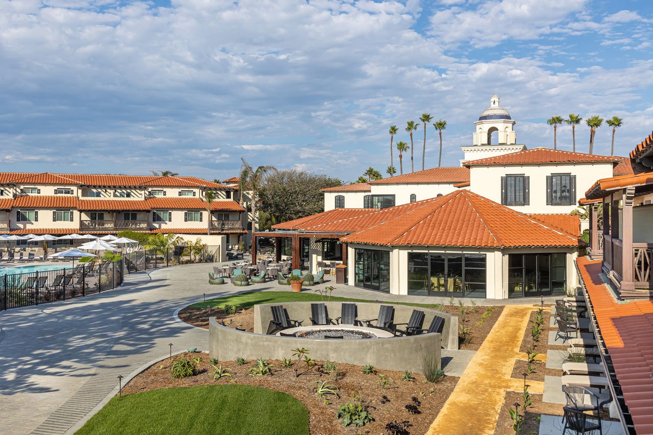 A luxury resort courtyard with a seating area pool and Mediterraneanstyle architecture
