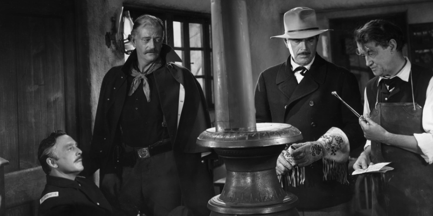 John Wayen and others gather around a stove in She Wore a Yellow Ribbon.