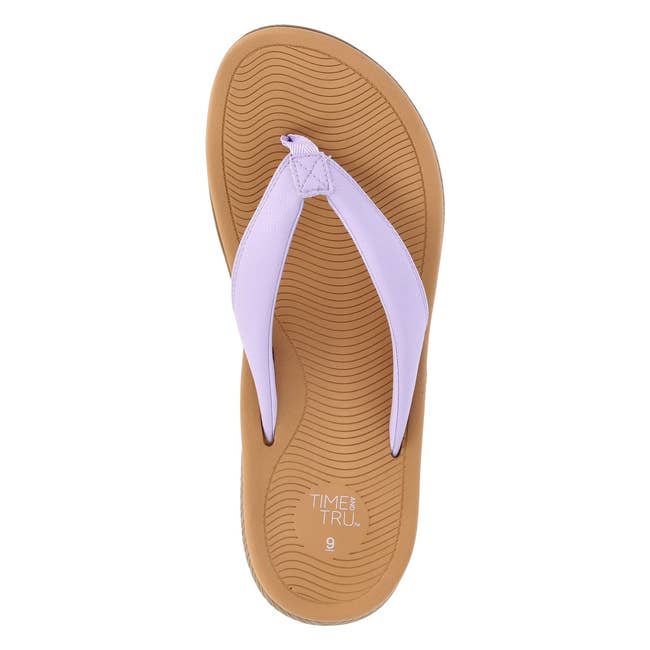 Top view of a single flip-flop sandal with a textured sole and strap, suitable for casual wear