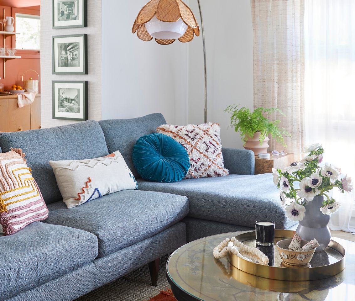Living room with a light blue couch and tulip lamp