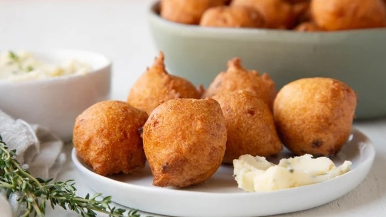 A plate of hush puppies with lemon honey butter