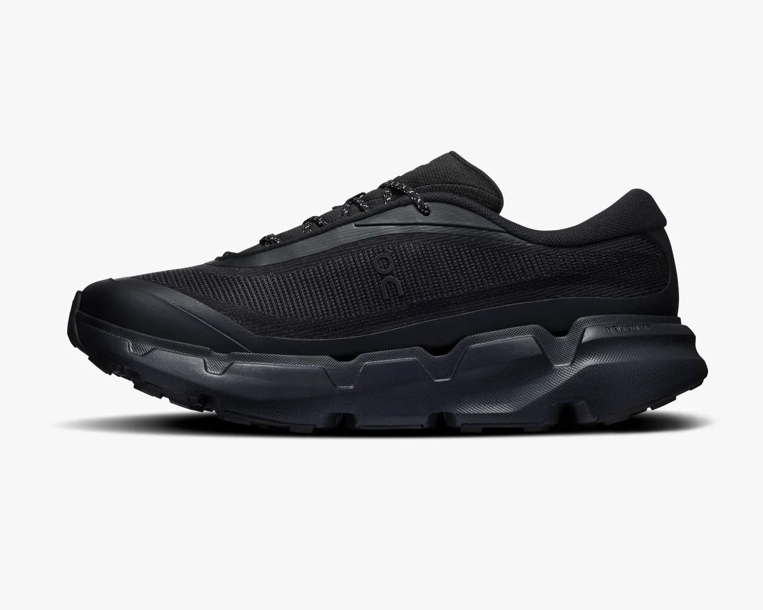 Black low-top athletic shoe with textured mesh upper and thick rugged sole.